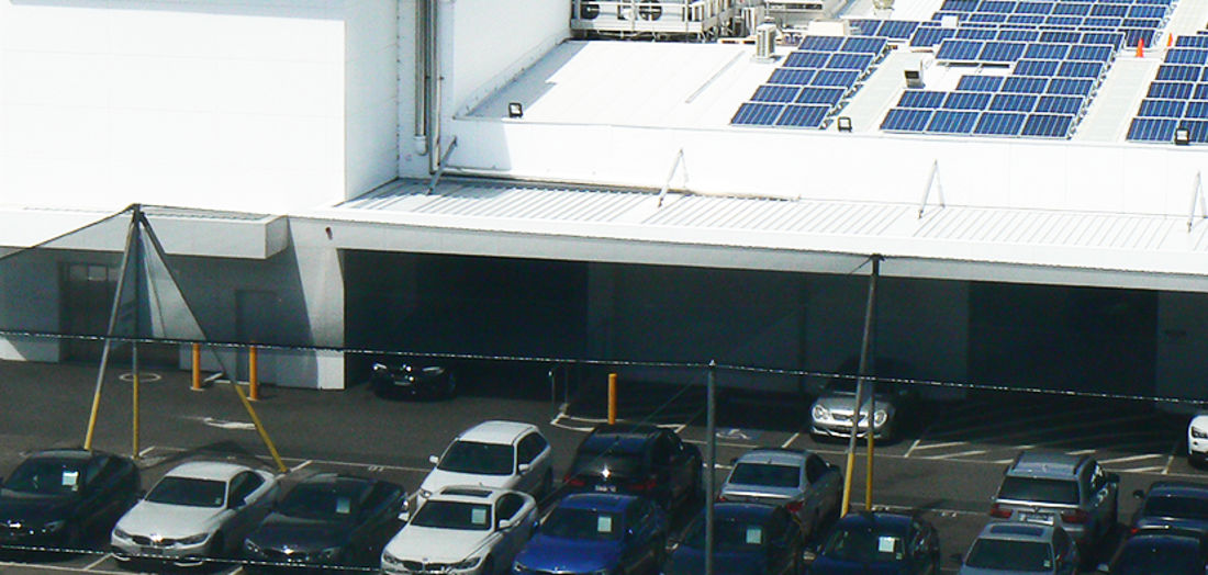 Car dealership with solar panels on roof Car dealership with solar panels on roof